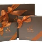 Two gift boxes tied with orange ribbons