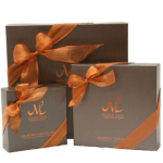 Three boxed chocolate gift sets tied with orange ribbons
