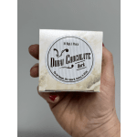 Hand holding a small box labeled Dubai Chocolate Dark