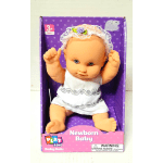 Baby doll in a purple box wearing a white outfit and lace headband