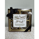Box of four milk chocolates tied with a black ribbon