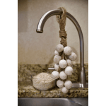 Decorative hanging bead garland on a metal hook above a sink
