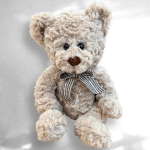 Plush teddy bear with a striped ribbon bow