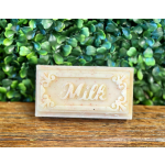 Rectangular soap bar labeled Milk on a wooden surface