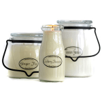 Three glass candles in jars with black handles and labeled fronts