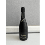 Black bottle of Freixenet Cava standing upright on a white surface