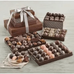 Assorted chocolate gift boxes and trays tied with a white ribbon