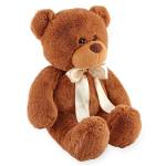 Brown plush teddy bear with a cream satin bow around its neck