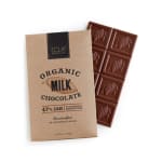 Organic milk chocolate bar with kraft paper wrapper and exposed section of scored chocolate squares