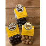 Three bags of malted milk balls in chocolate and peanut butter flavors