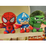 Three superhero plush toys on a shelf: Spider-Man, Captain America, and Hulk.