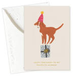 Birthday card with a dog wearing a party hat standing on a gift box