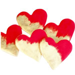 Six red and cream heart-shaped decorations on a white background
