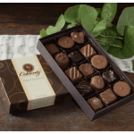 Box of assorted chocolates beside a leafy branch