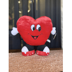 Red heart-shaped plush toy with a smiling face and small white arms and feet