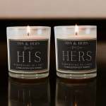Two lit glass candles labeled HIS and HERS on a dark surface