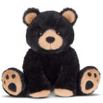 Black plush teddy bear with tan face and paws sitting upright
