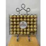 Ferrero Rocher chocolates arranged in a clear gift box on a metal stand