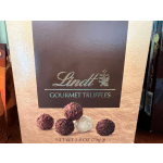Box of Lindt gourmet truffles with assorted chocolate pieces pictured on the front