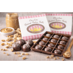 Box of chocolate peanut butter balls with open tray of truffles and scattered peanuts