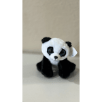 Small black-and-white plush panda toy sitting on a plain surface