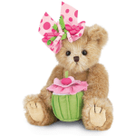 Teddy bear holding a pink flower pot and wearing a pink polka-dot bow