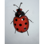 Red and black ladybug wall decoration on a white background