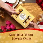 Hands holding a Ferrero Rocher chocolate box beside pink roses