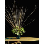 Tall arrangement of green flowers and dried branches in a blue vase