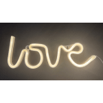 Neon wall sign spelling "love" in warm white light