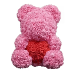 Pink rose teddy bear with a red heart on its chest