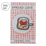 Enamel pin on a card that says Spread Love.