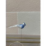 Small blue-and-white decorative bird on a thin wire stand