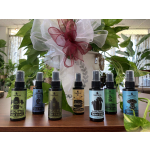 Potted plant with a large white and burgundy bow, surrounded by spray bottles on a table