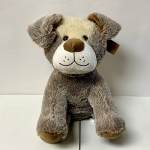 Plush teddy bear with brown and cream fur sitting upright