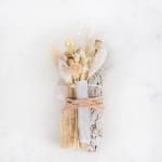 Dried floral bundle with white and beige accents tied with ribbon