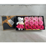 Gift box with a teddy bear and pink roses
