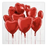 Cluster of red heart-shaped balloons on sticks