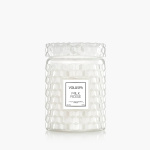 White textured glass jar candle with a Voluspa Milk Rose label on a white background