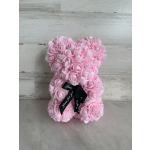 Pink rose-shaped teddy bear with a black ribbon bow