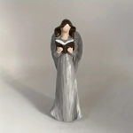 Angel figurine in a long silver gown holding a book