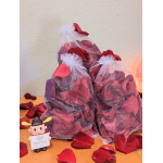 Two mesh bags filled with red rose petals sit on a table.