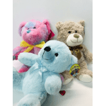 Three plush teddy bears with ribbons in pink, blue, and beige.