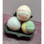 Three labeled bath bombs in a decorative tray