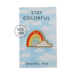 Enamel pin on a cloud-patterned card with a rainbow design