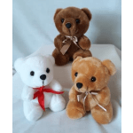 Three plush teddy bears with ribbons on a white surface