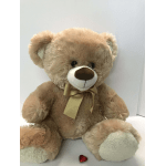 Plush teddy bear with a ribbon bow and a small red heart