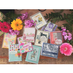 Assorted greeting cards with colorful flowers arranged around them
