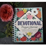 Pink rose beside a floral devotional puzzle journal