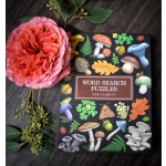 Pink rose beside a mushroom-themed word search puzzle book